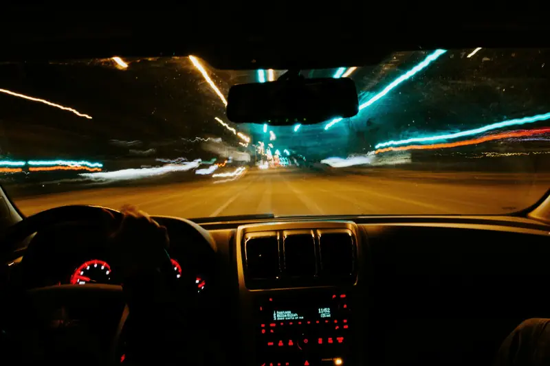 Night drive seen from the driver seat with light trails