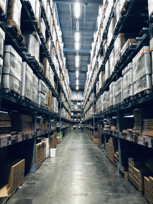 Long, cold-lit warehouse aisle with racked pallets