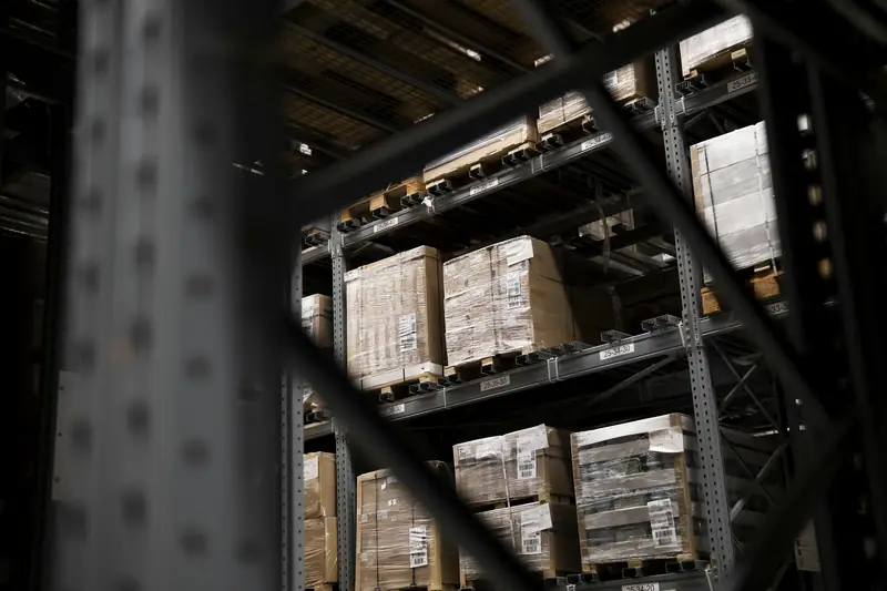 Warehouse racking with stacked boxes seen through steel uprights